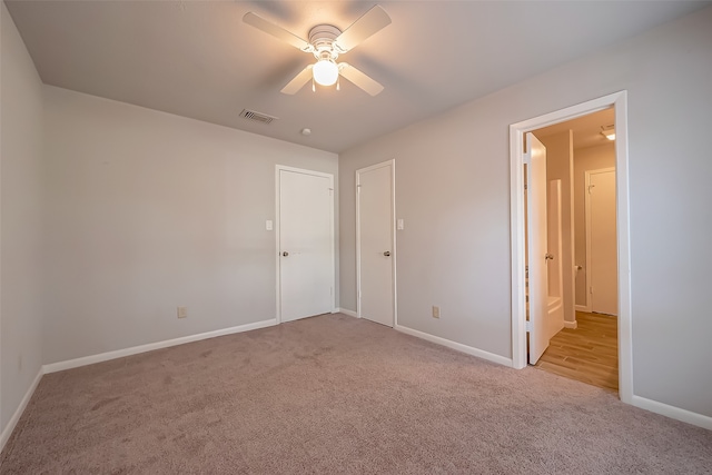 unfurnished bedroom with ceiling fan and light colored carpet