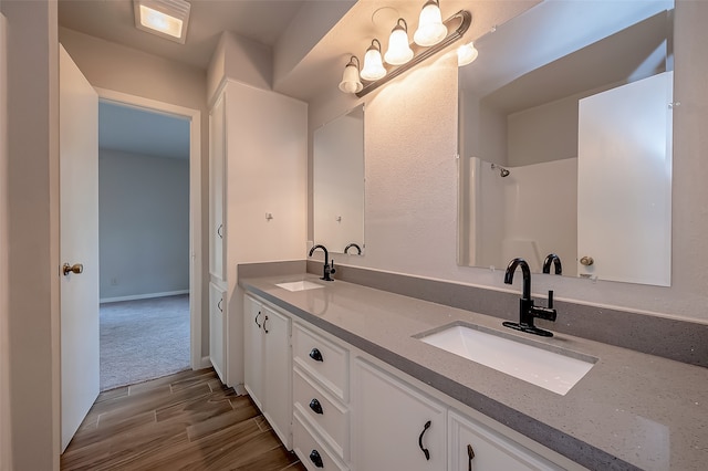 bathroom with hardwood / wood-style floors and vanity