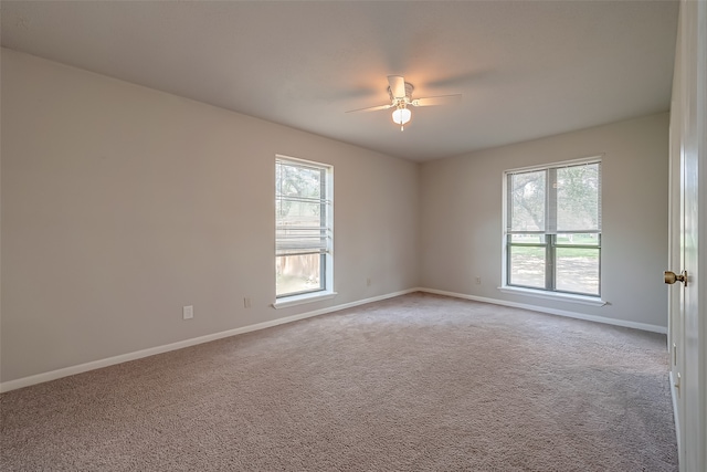 carpeted empty room featuring ceiling fan