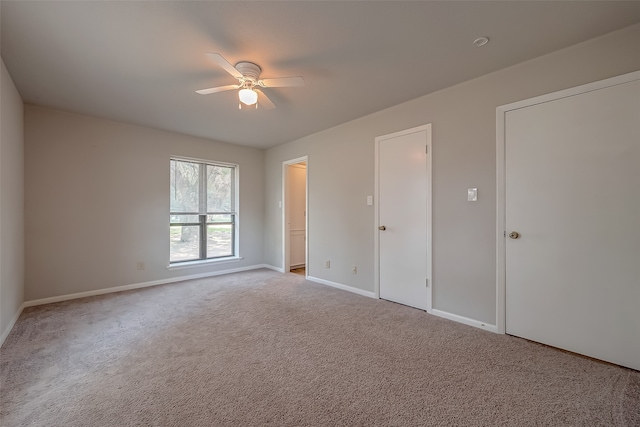 interior space featuring ceiling fan and light carpet