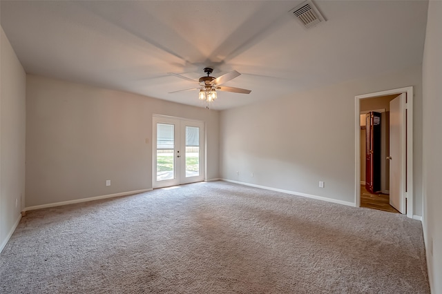 unfurnished room featuring light carpet, ceiling fan, and french doors