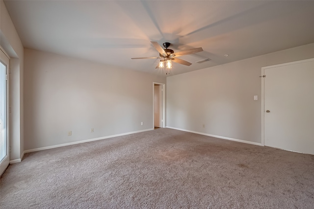 carpeted empty room featuring ceiling fan