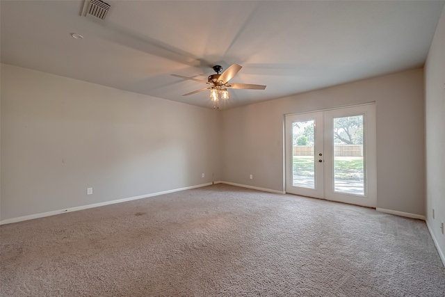 spare room featuring ceiling fan, light carpet, and french doors