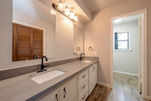 bathroom with vanity and hardwood / wood-style flooring