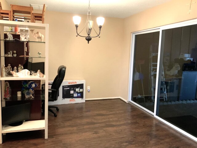 office space featuring an inviting chandelier and dark wood-type flooring