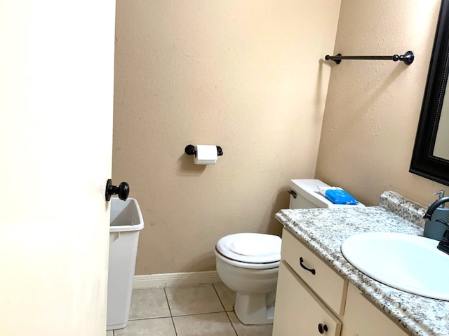 bathroom with vanity, toilet, and tile patterned floors