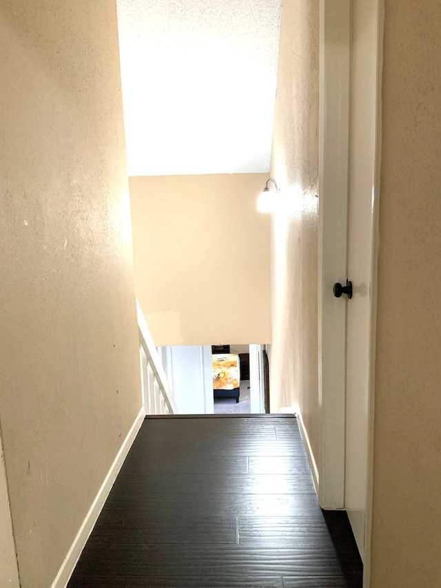 corridor featuring dark hardwood / wood-style floors