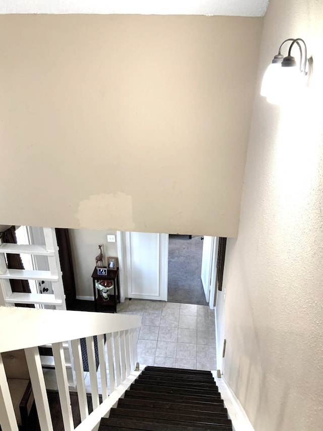 staircase with tile patterned floors