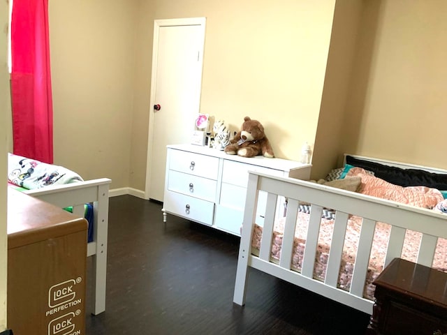 bedroom featuring dark hardwood / wood-style flooring