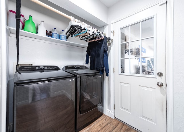 laundry room featuring independent washer and dryer and hardwood / wood-style flooring