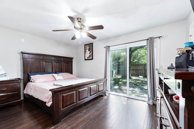 bedroom with ceiling fan, a textured ceiling, dark wood-type flooring, and access to exterior