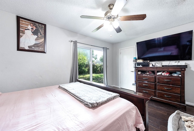 bedroom featuring a textured ceiling, ceiling fan, and dark hardwood / wood-style flooring