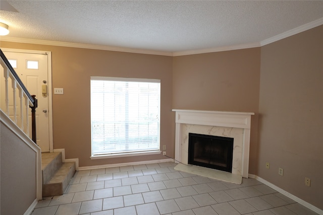 unfurnished living room featuring a textured ceiling, ornamental molding, light tile patterned floors, and a premium fireplace