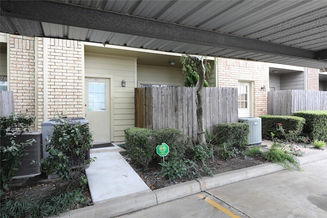 view of exterior entry featuring central AC unit