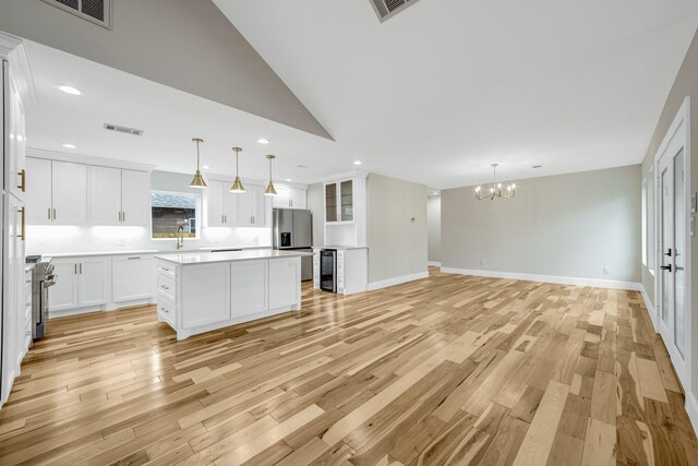 kitchen featuring white cabinets, light wood-type flooring, and a kitchen island