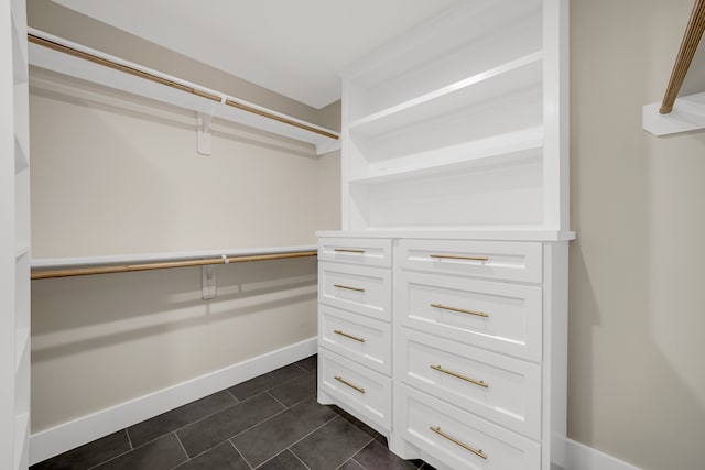 walk in closet featuring dark tile patterned flooring