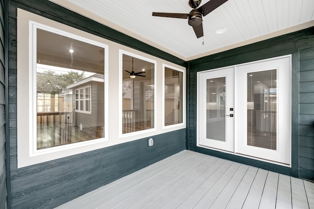 wooden terrace with ceiling fan and french doors