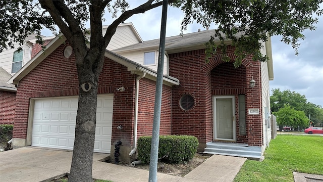 view of front of property featuring a garage and a front yard