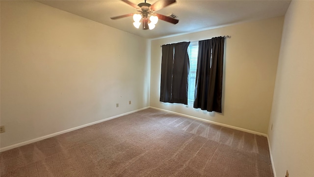 carpeted spare room featuring ceiling fan