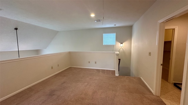 additional living space featuring lofted ceiling and carpet flooring