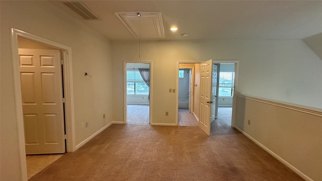 hall featuring light colored carpet