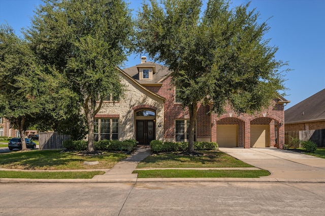 view of front of home with a garage and a front yard