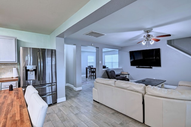 living room featuring light wood-type flooring and ceiling fan