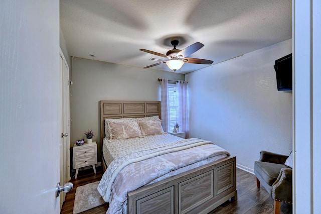 bedroom featuring a closet, a textured ceiling, ceiling fan, and dark hardwood / wood-style flooring