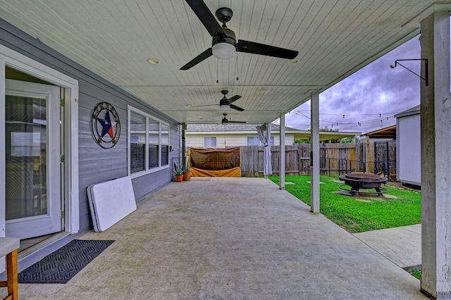 view of patio featuring ceiling fan and an outdoor fire pit