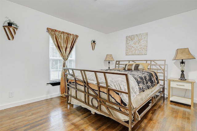 706 Beaumont St, Anahuac, TX 77514 - bedroom featuring wood finished floors and baseboards
