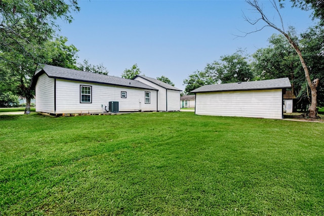 706 Beaumont St, Anahuac, TX 77514 - rear view of property featuring cooling unit and a yard