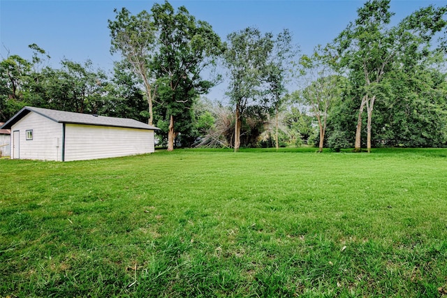 706 Beaumont St, Anahuac, TX 77514 - view of green lawn with an outdoor structure and view of scattered trees