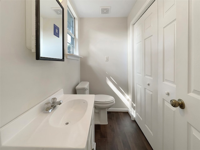 bathroom featuring wood-type flooring, vanity, and toilet