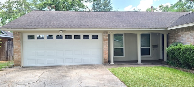 view of front of home featuring a front yard, a garage, and a porch