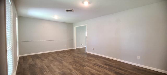 empty room featuring dark hardwood / wood-style flooring