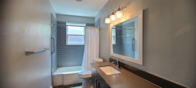 full bathroom featuring shower / bath combo, vanity, and toilet