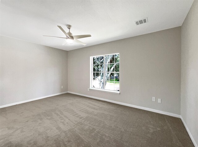 empty room with ceiling fan and carpet floors