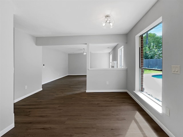 spare room with ceiling fan and dark hardwood / wood-style floors