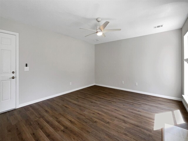 spare room featuring ceiling fan and dark hardwood / wood-style flooring