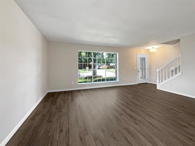 spare room with dark wood-type flooring