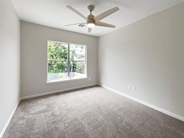 unfurnished room featuring ceiling fan and carpet floors