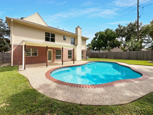 view of pool featuring a patio and a lawn