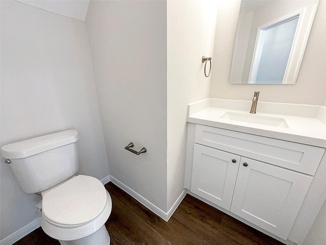 bathroom featuring vanity, toilet, and wood-type flooring