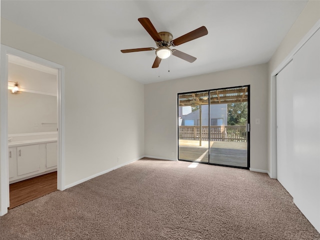 carpeted spare room with ceiling fan