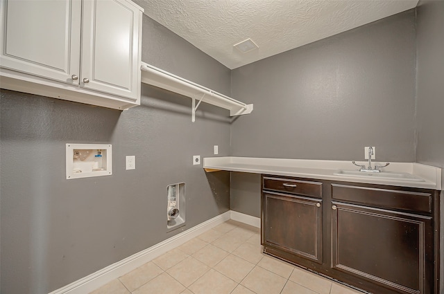 washroom with washer hookup, sink, a textured ceiling, cabinets, and electric dryer hookup