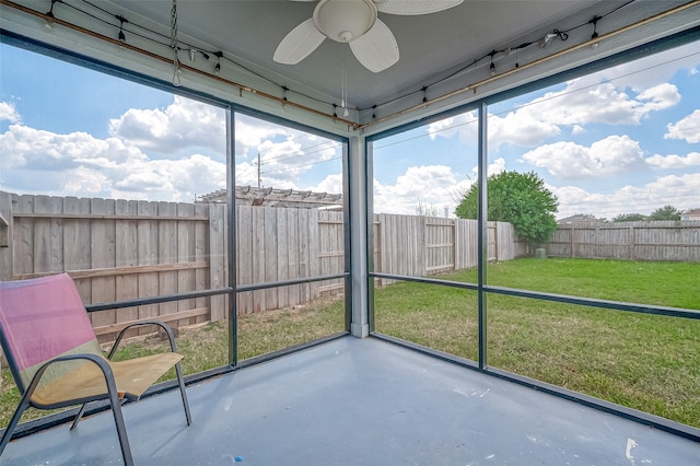 unfurnished sunroom with ceiling fan