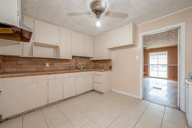 kitchen with ceiling fan, pendant lighting, backsplash, white cabinetry, and tile countertops