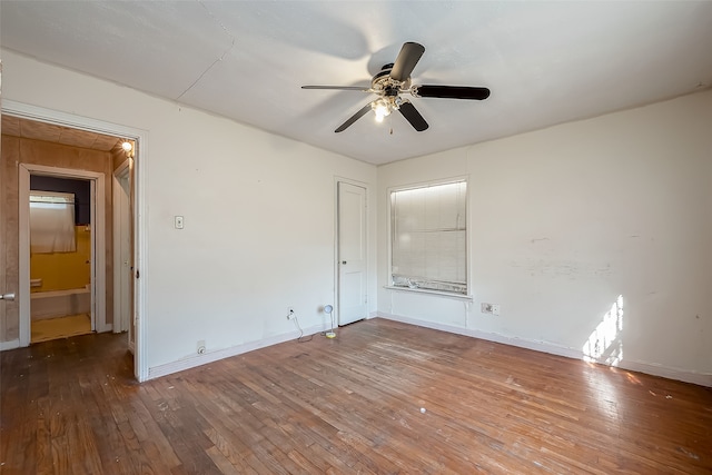 empty room with hardwood / wood-style floors and ceiling fan