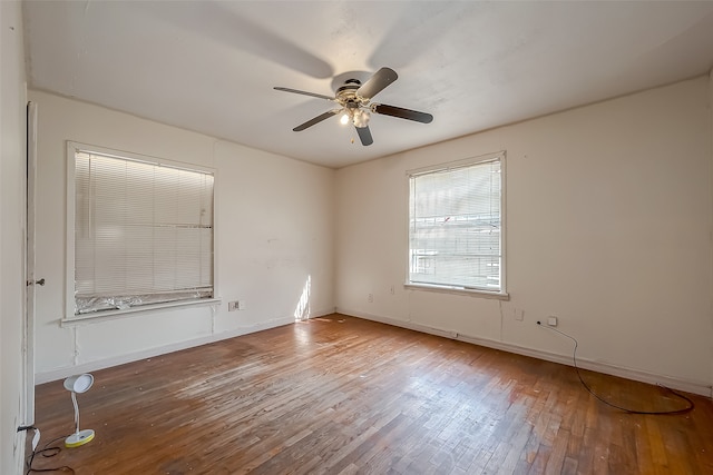 empty room with ceiling fan and hardwood / wood-style flooring