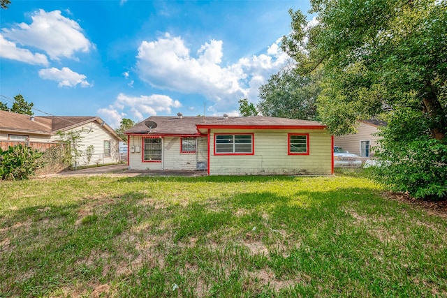 rear view of house with a yard and a patio area